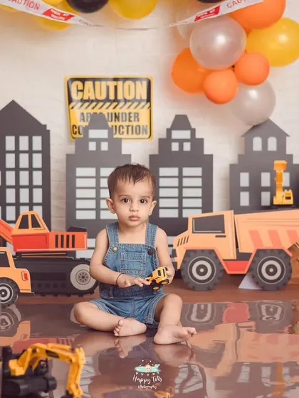 Caution, cutie under construction. This creative construction zone theme is filled with toy trucks, traffic signs, and a city skyline for a busy little builder.