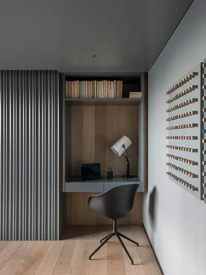 A view of the integrated study nook within the master bedroom of 'A Hint of Azul'. The desk and shelving are built into the wall, demonstrating our approach to creating functional zones within a cohesive design.