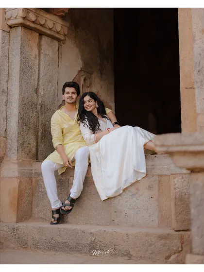 A quiet moment of togetherness on ancient stone steps. This portrait from their pre-wedding shoot has a timeless, storybook quality.