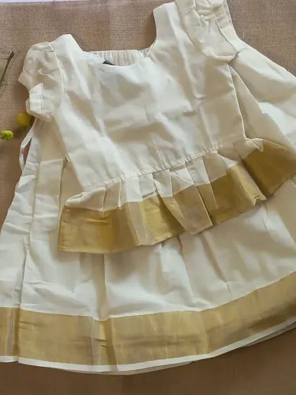 For our Vishu and Onam collection, I created this classic Kasavu on Kasavu paavada blouse. The peplum style top adds a modern touch to the traditional off-white and gold cotton fabric, perfect for celebrating southern festivals.