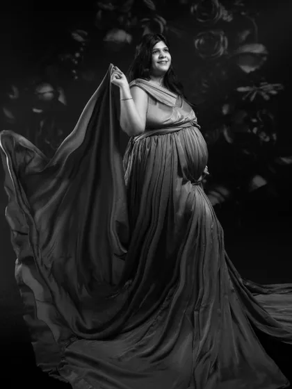 Embracing timeless elegance, this stunning black and white maternity portrait is a blend of classic artistry and modern creativity.