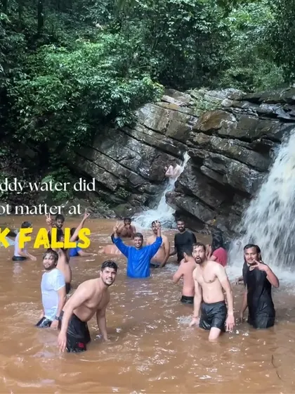 The fun doesn't stop even if the water is muddy. Our group enjoying a dip in a waterfall near Kudremukha.