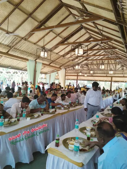 We can cater to any venue, transforming it to accommodate a large dining setup. This image shows a rustic hall filled with guests enjoying our food.