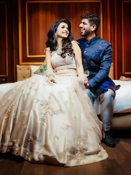 A romantic indoor portrait of the couple, with warm, ambient lighting.
