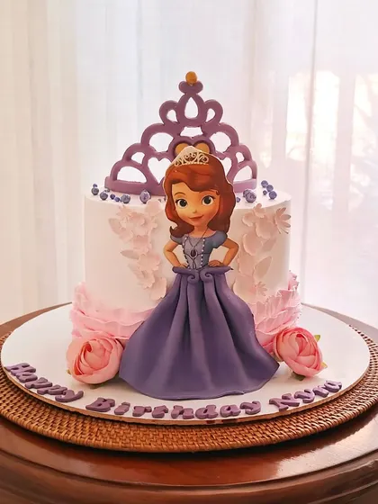 A Princess Sofia the First cake, featuring a 3D fondant skirt for the princess and a beautiful purple crown topper.