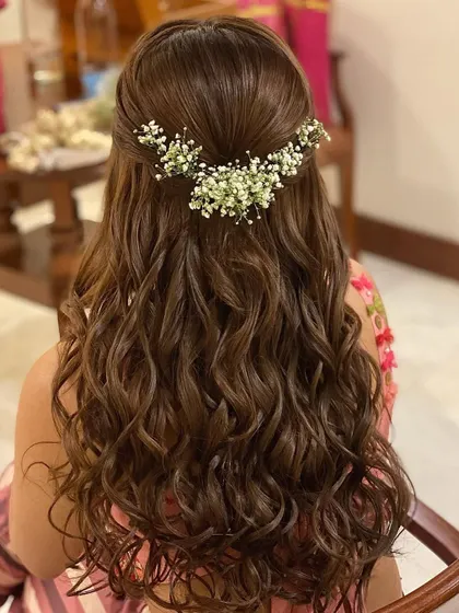 I love adding delicate baby's breath to messy curls. The extensions create a full canvas of hair, allowing the flowers to nestle in beautifully for a whimsical, romantic style.