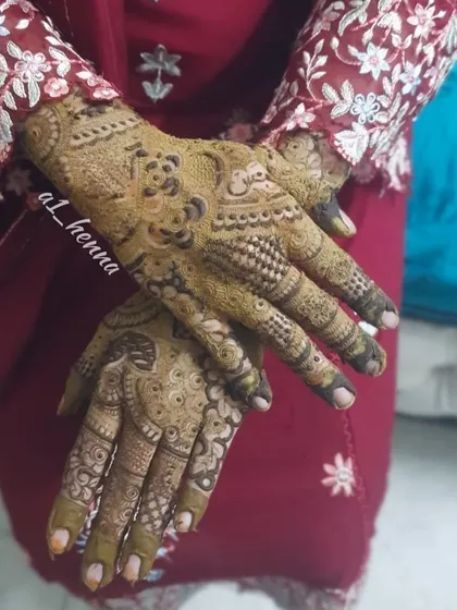 A candid shot showing the intricate details of the henna design in a natural pose.