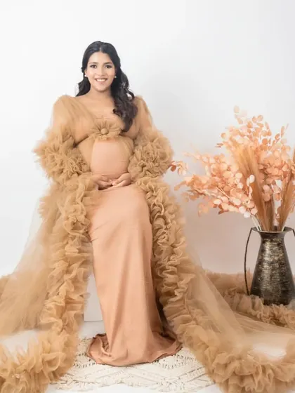Here is the same gorgeous beige tulle gown, but styled differently with a simple white background and pampas grass decor. This shows how we can change the mood of the photo with just a few adjustments in the studio.
