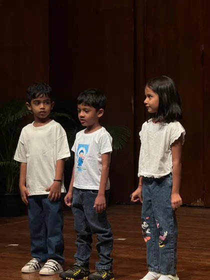 A trio of young actors completely focused and in character during their scene.