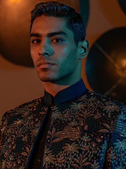 A close-up portrait highlighting the exquisite embroidery on a contemporary jacket from our Raaya collection. The detail showcases the harmonious blend of traditional craftsmanship and modern design.