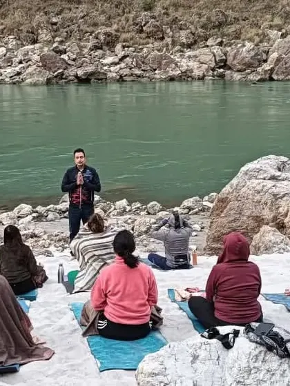 A teacher leads a session on the banks of the Ganges, sharing wisdom in the very place where yogic traditions have flourished for centuries.