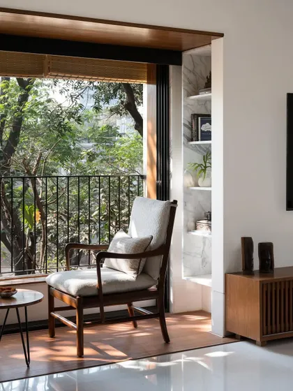 We create intimate moments within a home, like this quiet seating area for two. By perfectly framing the lush greenery outside, we turn a simple window into a private retreat, blending the interior with nature.
