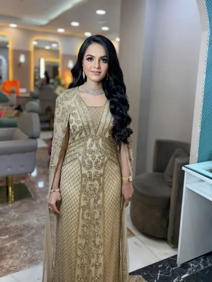 A full-length view of her stunning golden gown.