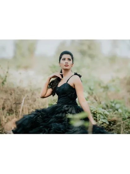 A fantasy-inspired outdoor shoot with a horse. This portrait creates a powerful, almost mythical narrative, combining a dramatic black gown with the natural beauty of the animal.