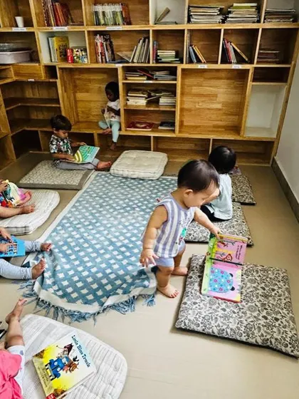 An overview of our reading nook, filled with children enjoying books. This child-led activity is a cornerstone of our daily routine.