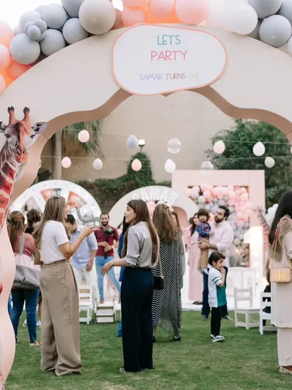 Guests enjoying the party under a welcoming arch. This shot captures the lively and happy atmosphere of the celebration.