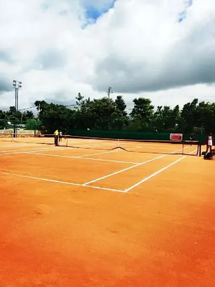 A wide view of my professionally maintained clay courts at the Tennis360 academy, prepared for a day of competitive AITA tournament matches.
