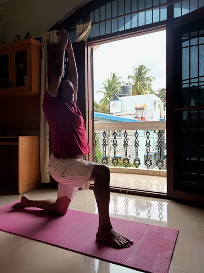 Our personal training extends to the comfort of your home. This is Pratap during his at-home session, working on Anjaneyasana (Low Lunge) to improve flexibility and strength as part of his customized fitness plan.