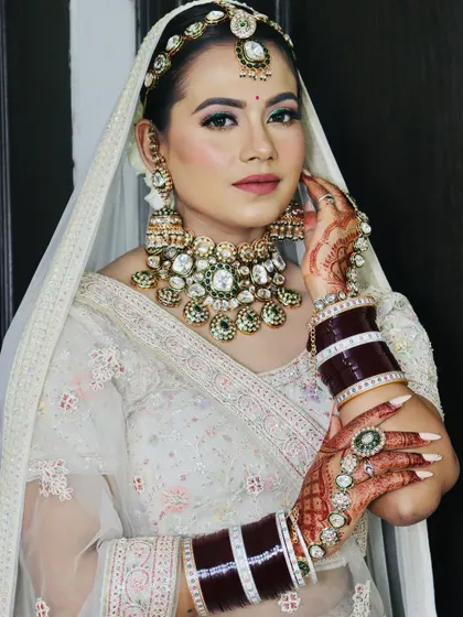 The bride looking at the camera, her makeup looking fresh and radiant.