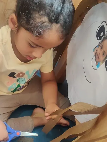 This girl practices her cutting skills with determination. I create activities that are not only educational but also resonate with children's real-world experiences.