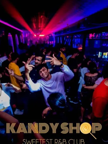 The view from my DJ booth, with laser lights cutting through the darkness over a packed dance floor. This is the peak energy I strive for in every set.