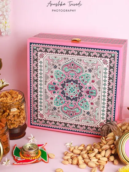 A closed view of the pink Diwali hamper, showcasing its intricate mandala-inspired design.
