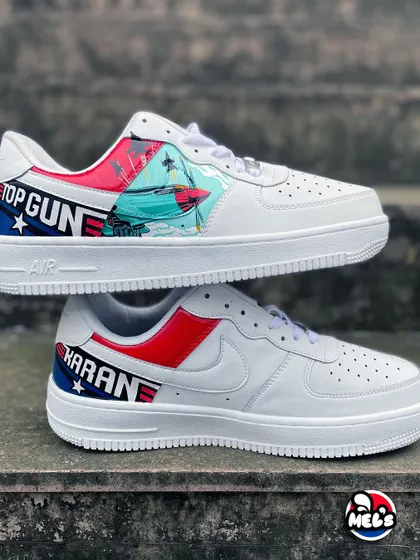 A full view of the outer sides of the 'Top Gun' custom pair. One shoe has the jet and logo, and the other is personalized with the name "KARAN."