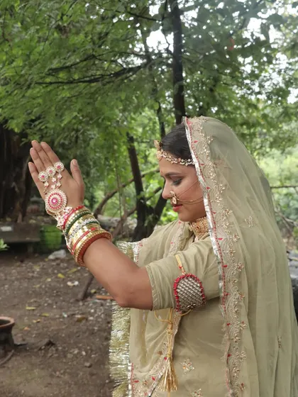 The side profile of a Rajasthani bride, showing the delicate 'nath' and the graceful drape of the 'odhni'.