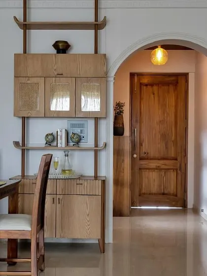 Cozy dining meets natural elegance. This view from the dining area into the arched hallway shows how I use materials like rustic wood and cane to create a warm, inviting, and cohesive flow through the home.