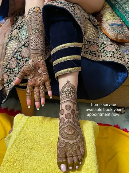 A partial view of a hand and foot mehndi combination. The foot design is elegant and matches the intricate patterns on the hand. Home service is always available.