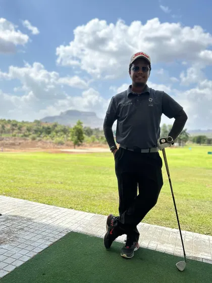 A coach takes a moment on the practice range. Our team is always ready to help you with your game, whether you're a beginner or an experienced player.