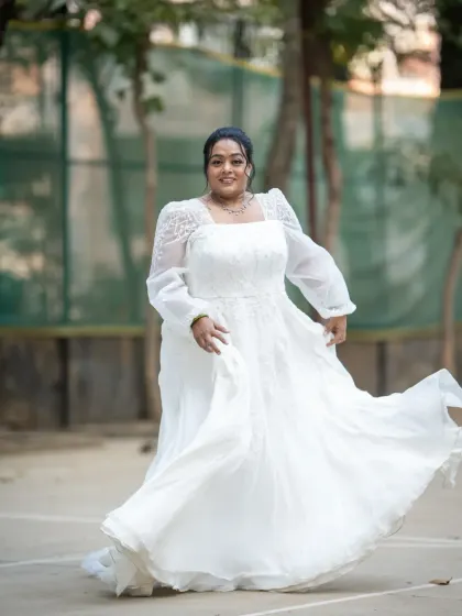 A joyful, twirling bridal portrait. This shot is full of movement and happiness, perfectly capturing the bride's excitement on her wedding day.