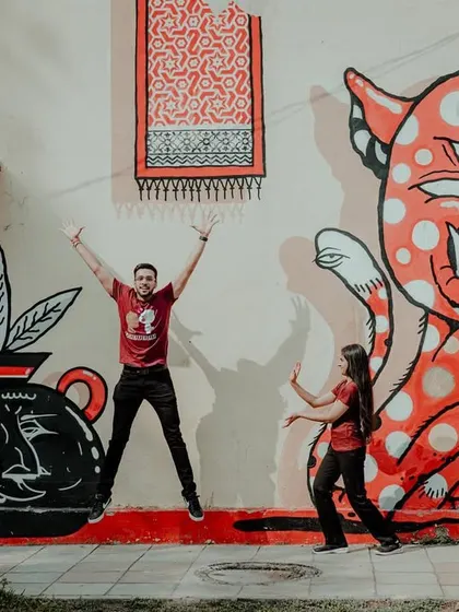 A playful, high-energy jump in front of a quirky mural. Our goal is to make your pre-wedding shoot fun, resulting in photos that are full of life and personality.