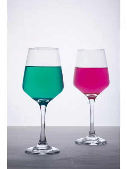 The same wine glasses are filled with colorful liquids to demonstrate their shape and clarity. This is a common technique used to make glassware photography more vibrant and visually interesting.