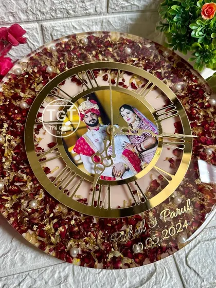 This 12-inch round clock features a photo at the center, surrounded by preserved red rose petals from the couple's varmala. The golden Roman numeral dial adds a classic, luxurious touch.