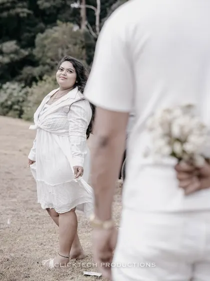 A creative shot in Ooty, with the groom holding flowers behind his back, creating a sense of anticipation.
