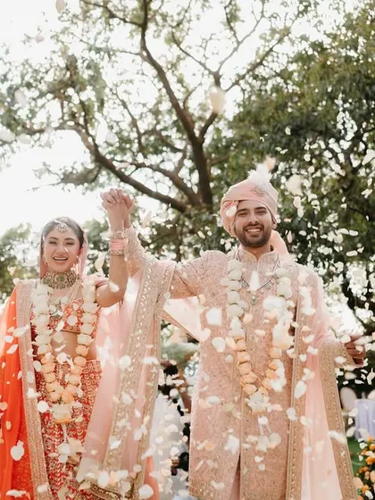 A shower of petals for the happy couple. This photo captures the pure joy of the moment, surrounded by the beautiful ombré floral decor of their garden wedding.