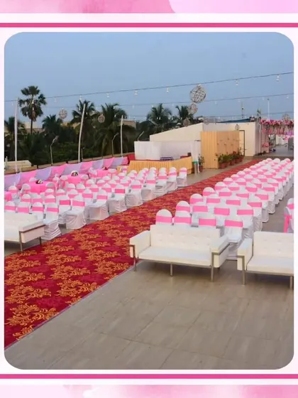 Guest seating for a large outdoor wedding, with pink sashes on the chairs to match the overall theme. The red patterned aisle runner adds a touch of traditional contrast.