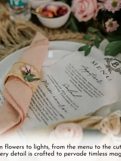 Every detail on the table is crafted to create a feeling of timeless romance. From the custom-printed menu to the delicate floral napkin rings, this setup invites guests to a truly special dining experience.