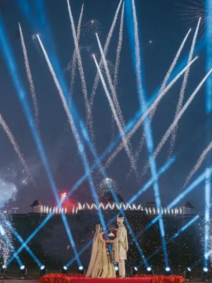 A spectacular display of fireworks and lights creates a magical moment for the couple against the palace facade. We specialize in choreographing these large-scale effects for maximum impact.
