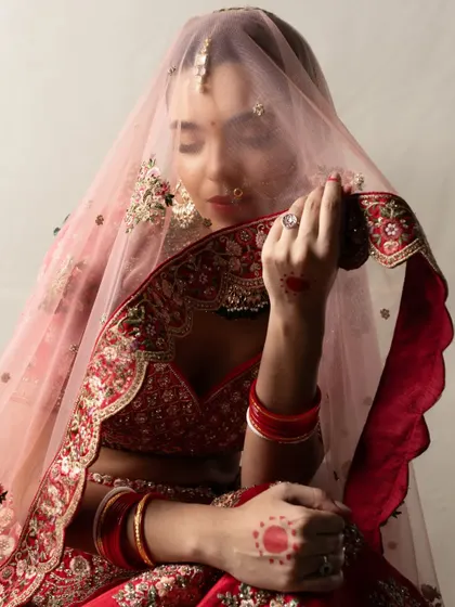 Another beautiful pose from the editorial bridal shoot, with the bride holding her veil. The soft lighting and her gentle expression make for a classic and romantic frame.
