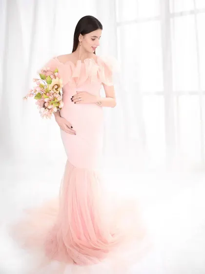 A vision in pink, this portrait features a stunning mermaid-style gown with a tulle train. The high-key lighting and soft colors create a sweet, romantic, and utterly dreamy image.