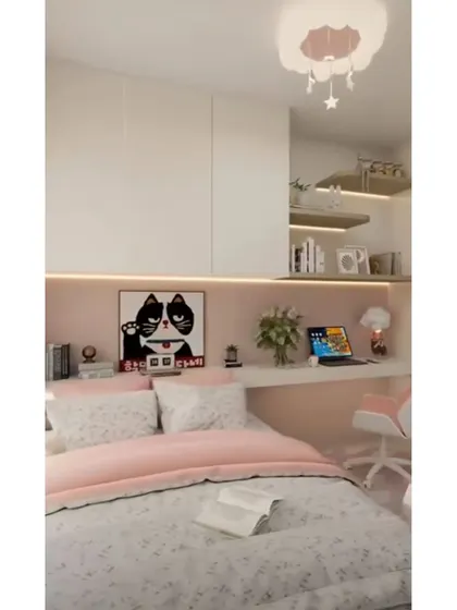 A cozy and chic girl's bedroom with a built-in desk and shelving. The soft pink and white color scheme, along with whimsical art, creates a dreamy and functional space.