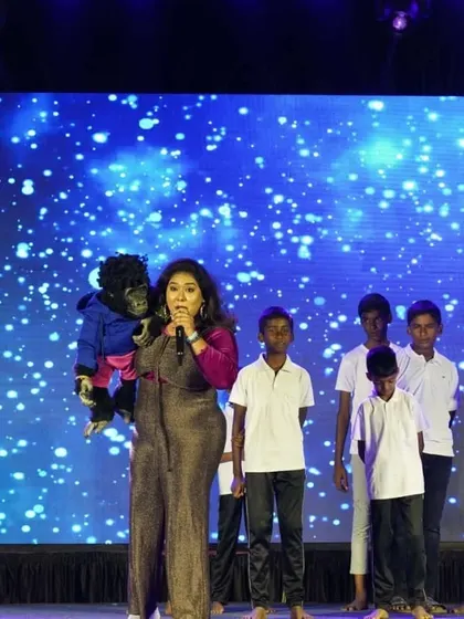 Leading a group of kids in a fun activity on stage. Our shows are highly interactive, making the audience the real stars.