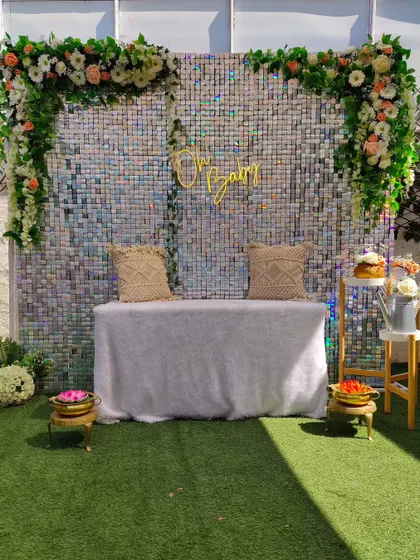 Here is another version of the sequin backdrop, styled for a traditional "Oh Baby" ceremony. The setup includes a covered table for rituals, blending modern glamour with cultural traditions.