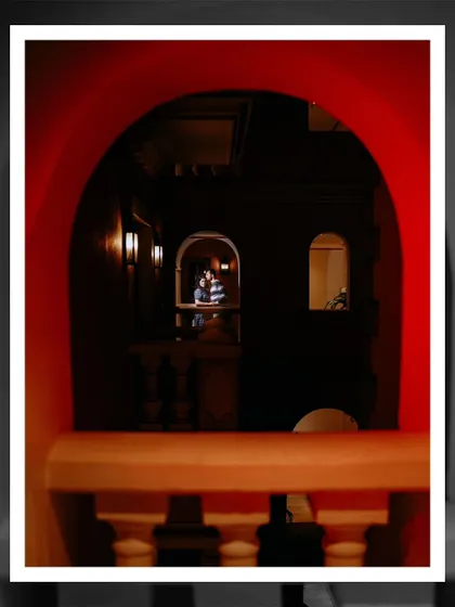 A creatively framed shot of the couple through an archway, adding depth and an artistic touch to their Goa pre-wedding photos.