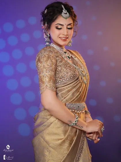 A beautiful reception look featuring a golden saree with diamond and emerald jewelry. You'll learn to work with different types of jewelry.