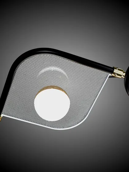 A close-up of the textured glass and metal details of the leaf-panel chandelier.