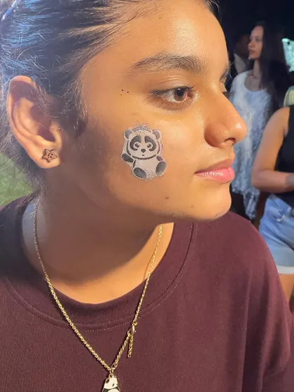 A clear shot of the finished panda face paint. It's an adorable design that works for any fun occasion.