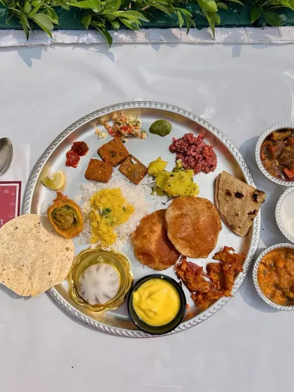 A complete Maharashtrian thali served at one of my Pangat events. It features a balanced assortment of dishes, including vegetables, lentils, breads, rice, and of course, a sweet Modak.
